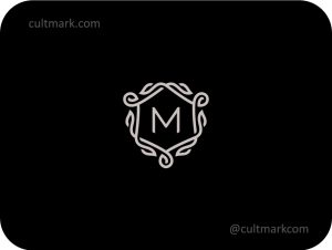 Cultmark Elegant Letter M Shield logo, minimalist ornate heraldic symbol with decorative flourishes for luxury hotel, real estate, or premium law firm business identity on black background.
